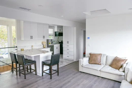 Open-plan living room and kitchen with island seating